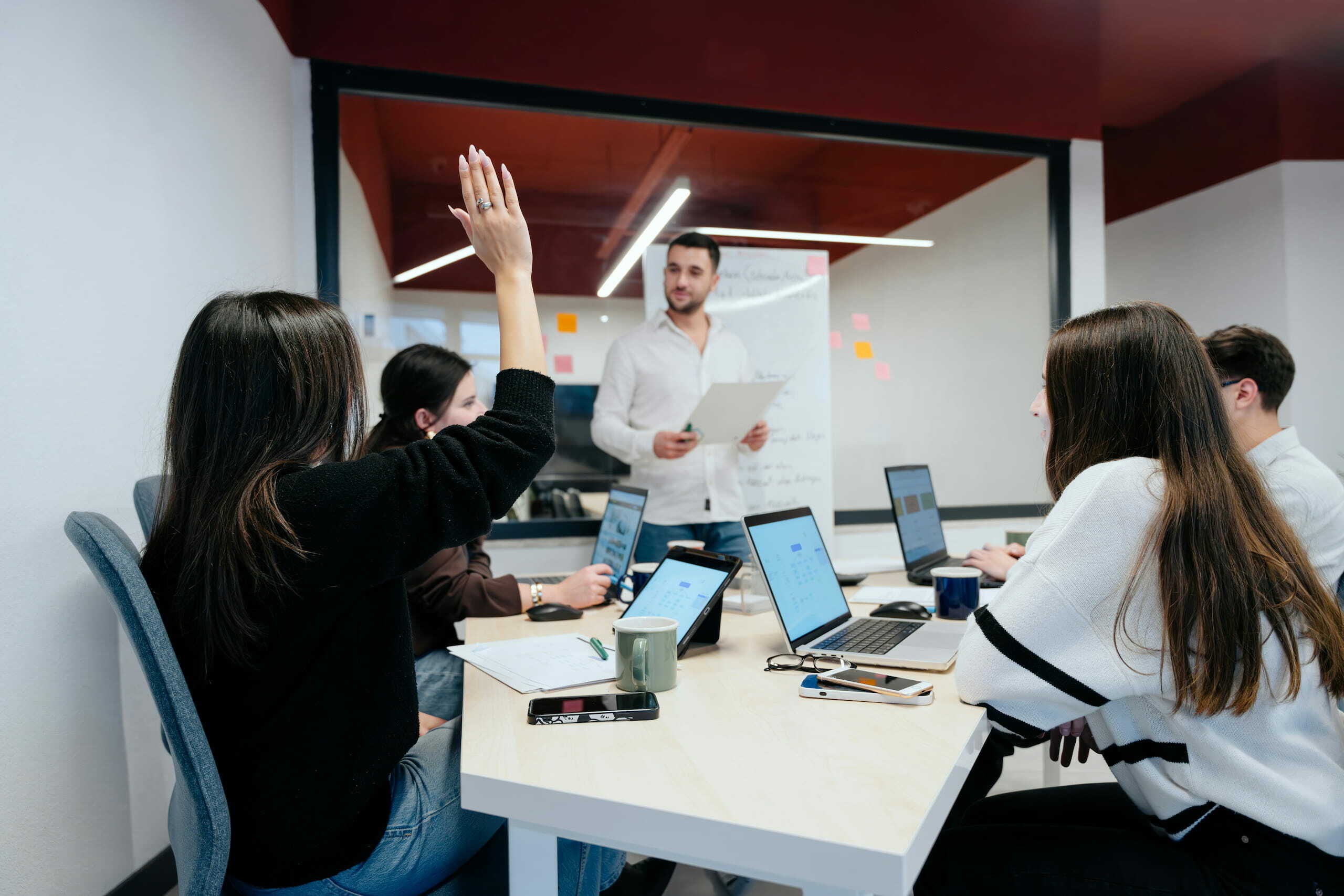A person in a room of people giving a presentation