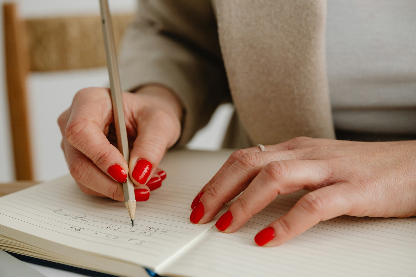 A person writing something down on a piece of paper