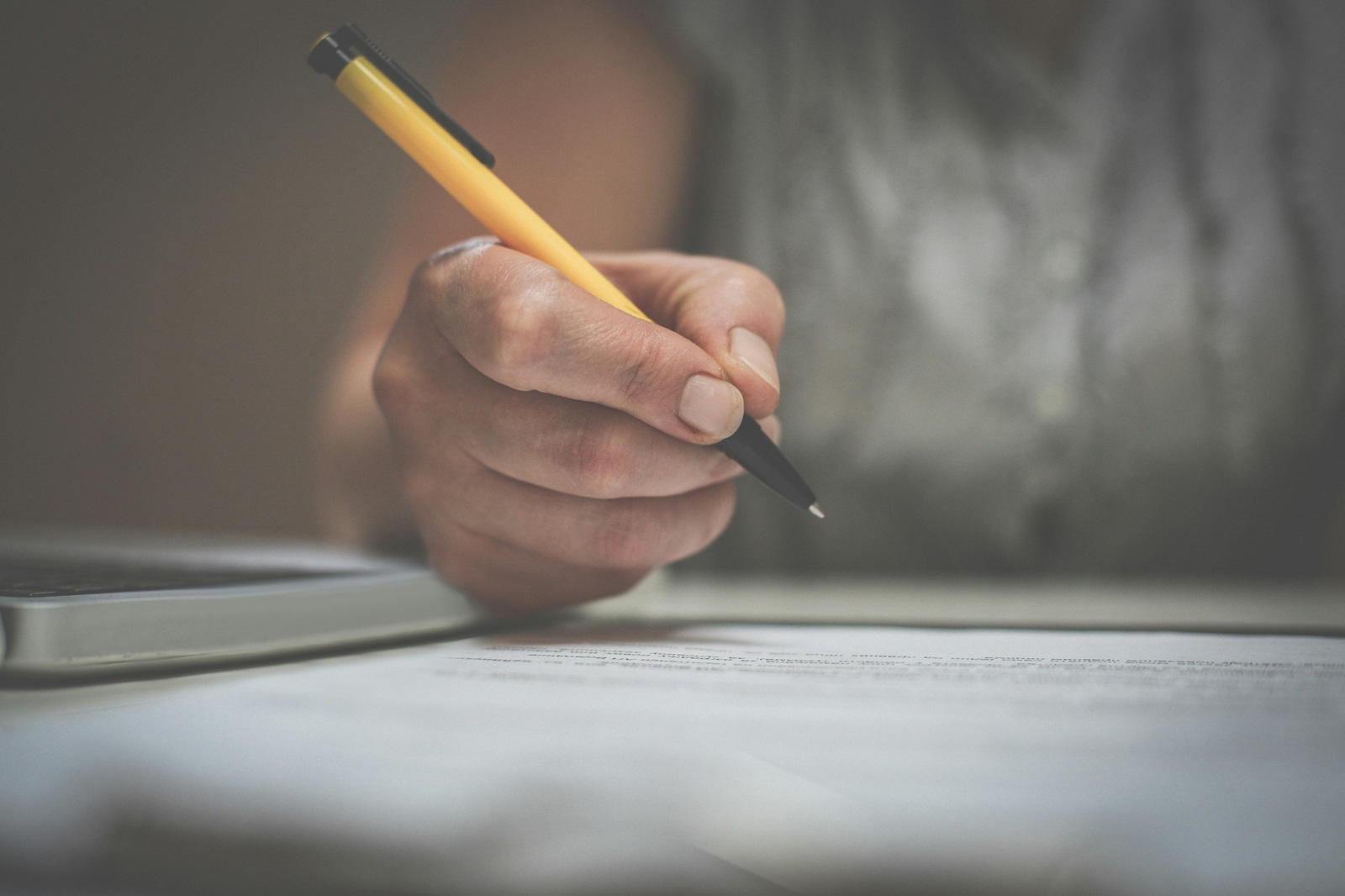 Close up of a woman struggling with common grammatical errors in writing