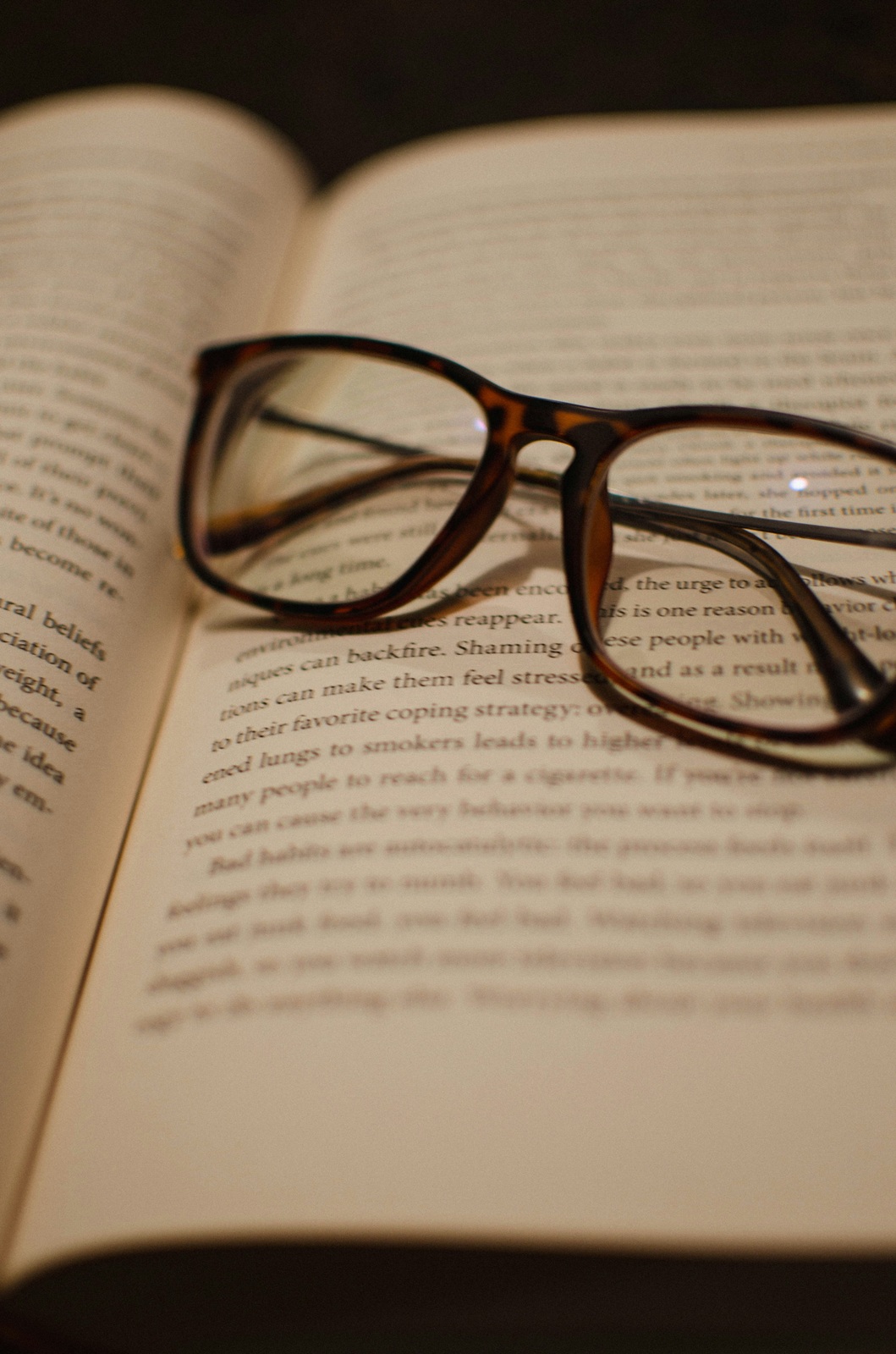 A pair of glasses on an open book