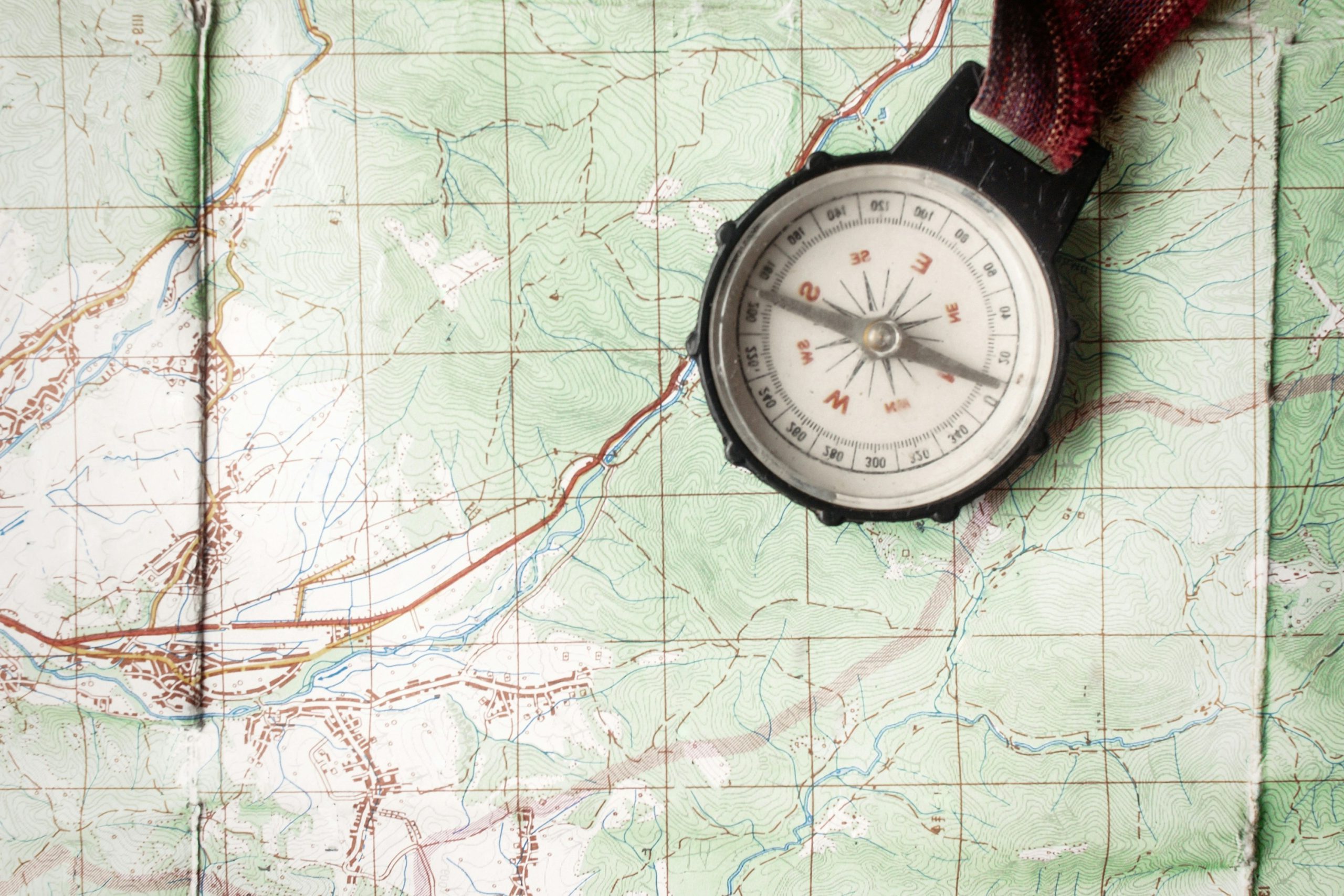 paper colored map with a compass