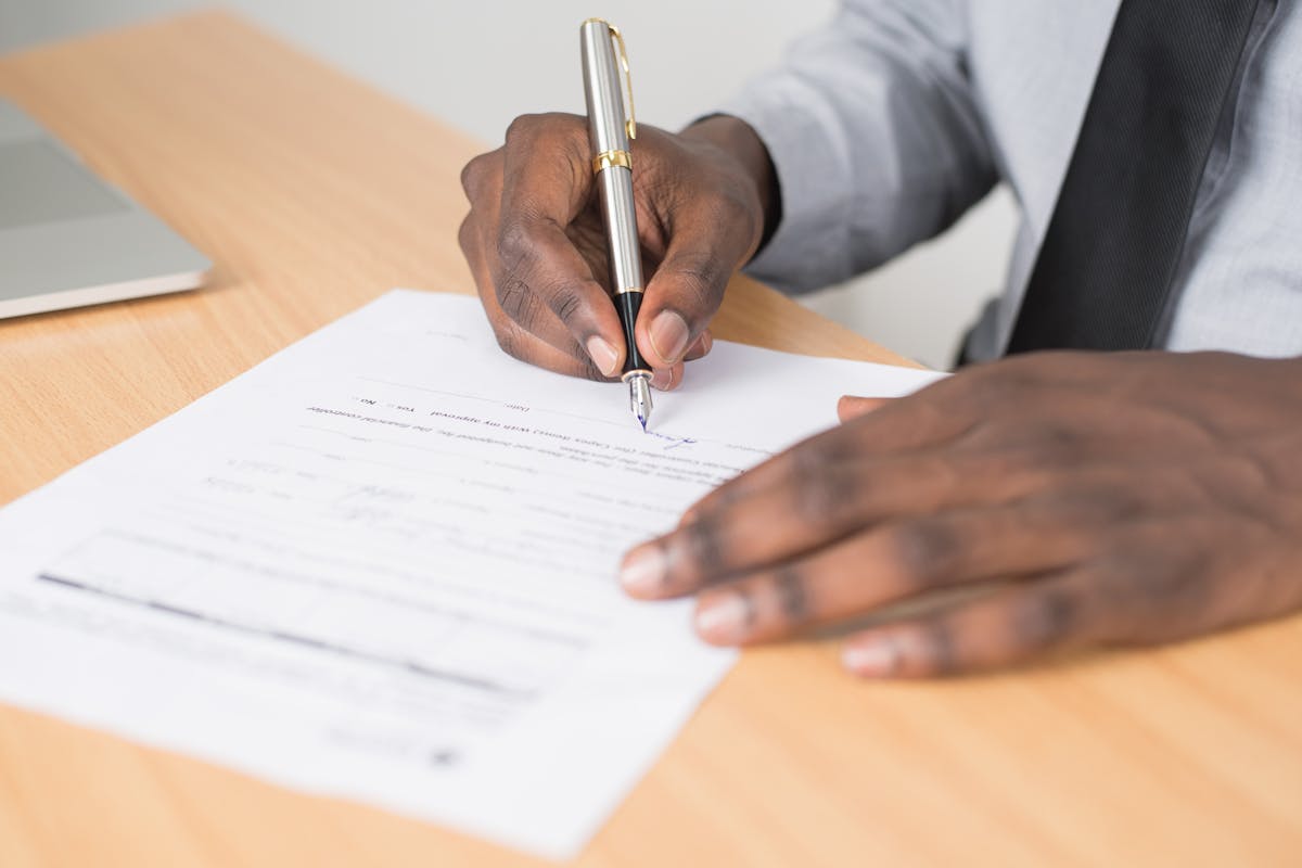 A business man signing a document