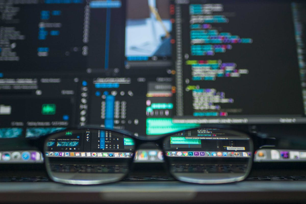 Glasses sitting on a desk looking at a computer screen