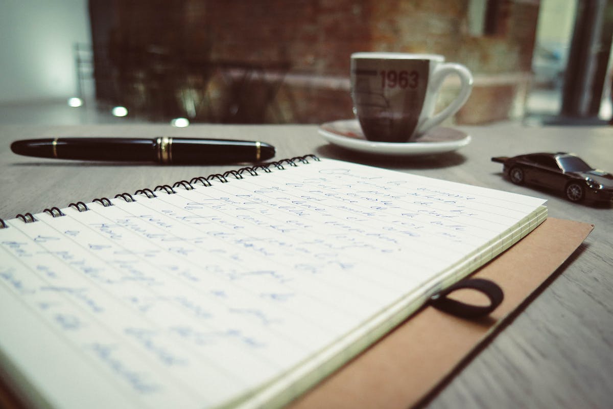 A notebook that has a ton of writing in it from a pen