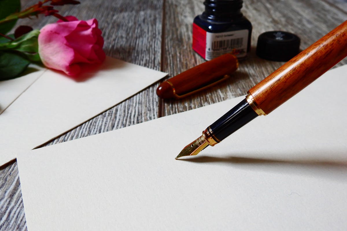 A pen about to write on some white paper