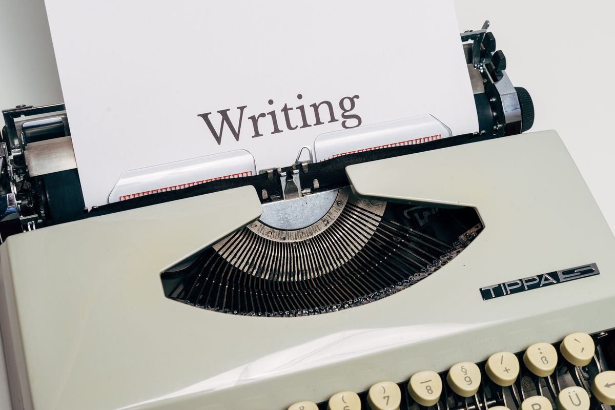 A typewriter with the word Writing on a piece of paper inside it